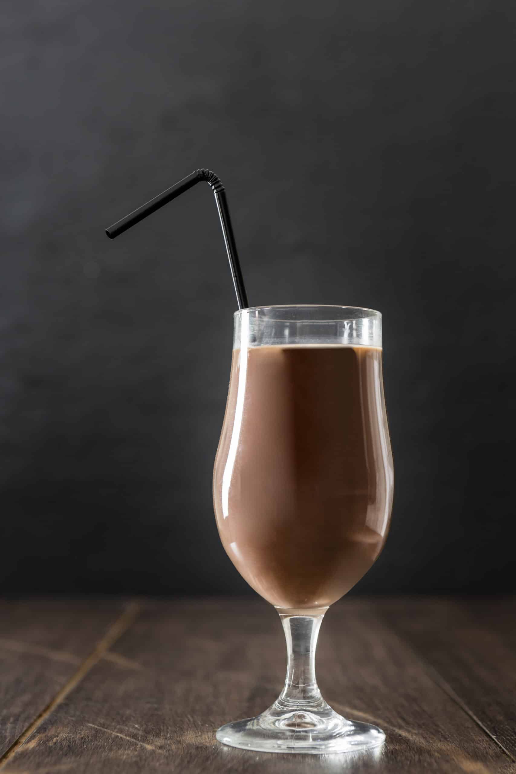 glass chocolate milkshake with straw copy space scaled